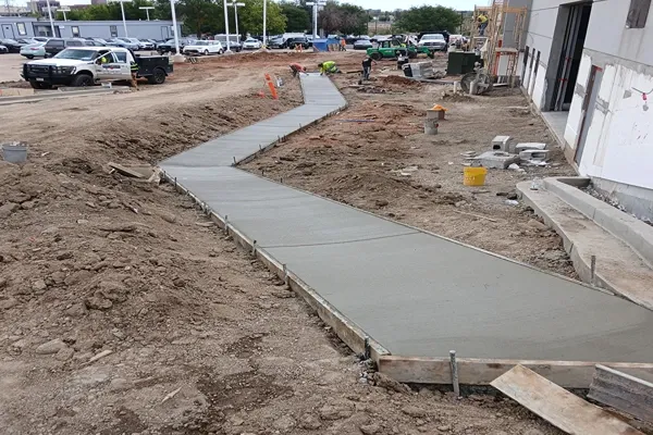 Long concrete sidewalk poured at a commercial construction site in Colorado Springs