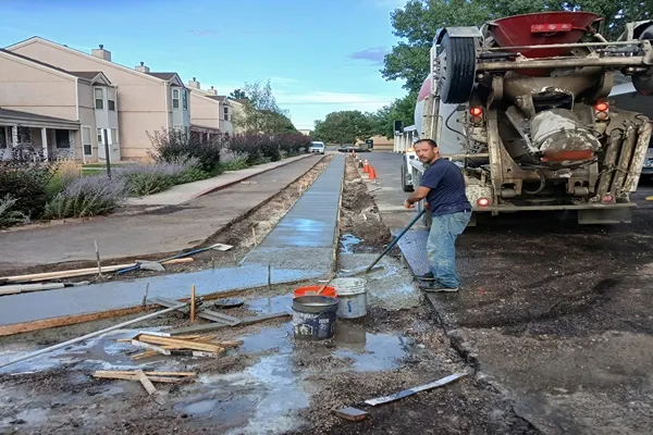 Concrete sidewalk pour with a mixer truck and crew in Colorado Springs