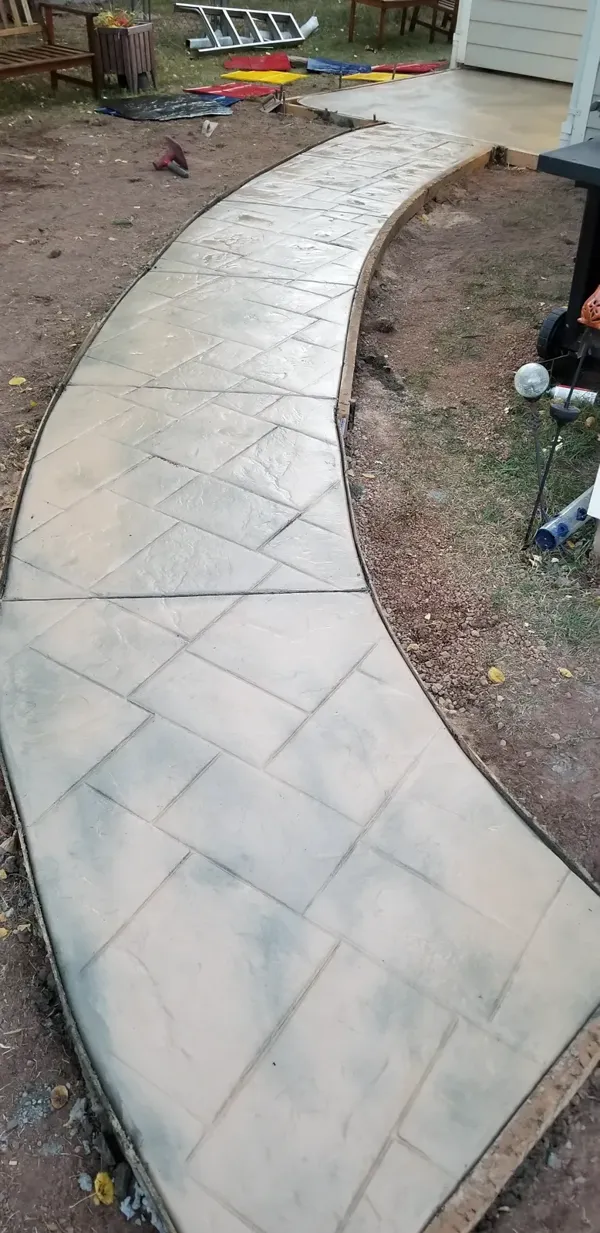 Freshly stamped curved concrete walkway in Colorado Springs