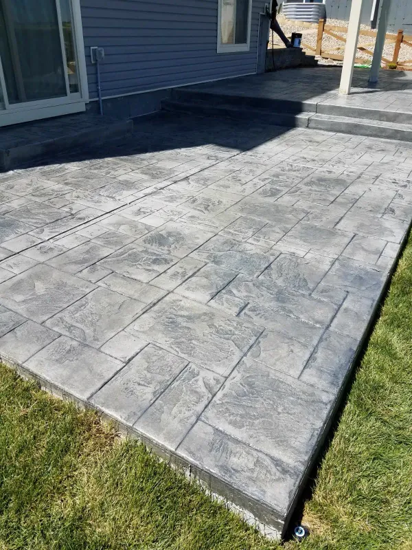 Dark gray stamped ashlar concrete patio with steps in Colorado Springs