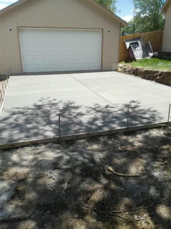 New concrete driveway poured in front of a detached garage in Colorado Springs