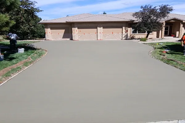 Freshly poured concrete driveway with a curved edge at a Colorado Springs home