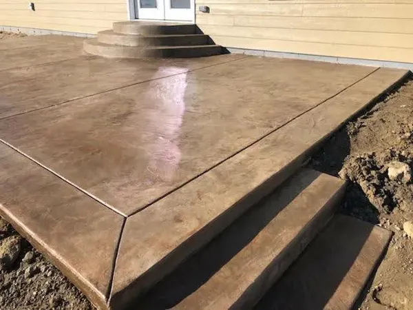 Stained brown concrete patio with round steps in Colorado Springs