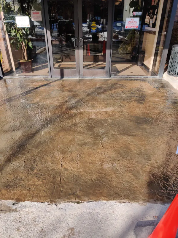 Stamped concrete overlay at a commercial building entrance in Colorado Springs