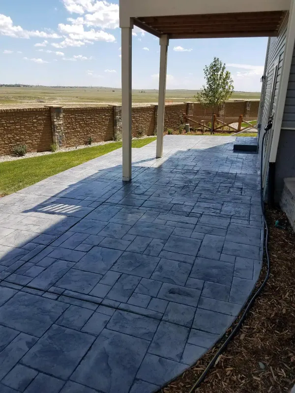 Blue-gray stamped slate concrete patio under a covered porch in Colorado Springs