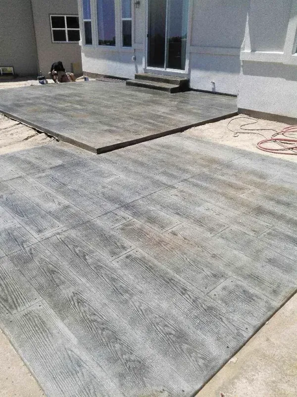 Gray wood-plank stamped concrete patio with a stamped border in Colorado Springs