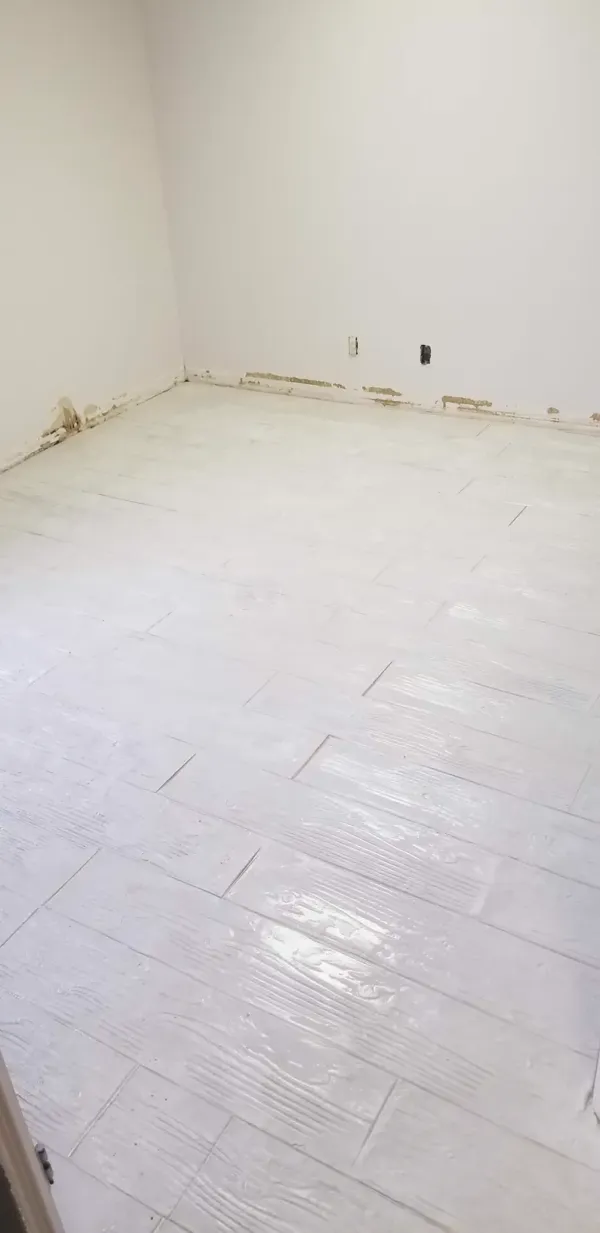 White wood-plank stamped concrete overlay on an interior floor in Colorado Springs