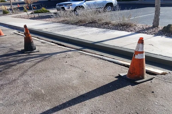 Concrete curb and gutter forms set and ready to pour along a parking lot in Colorado Springs