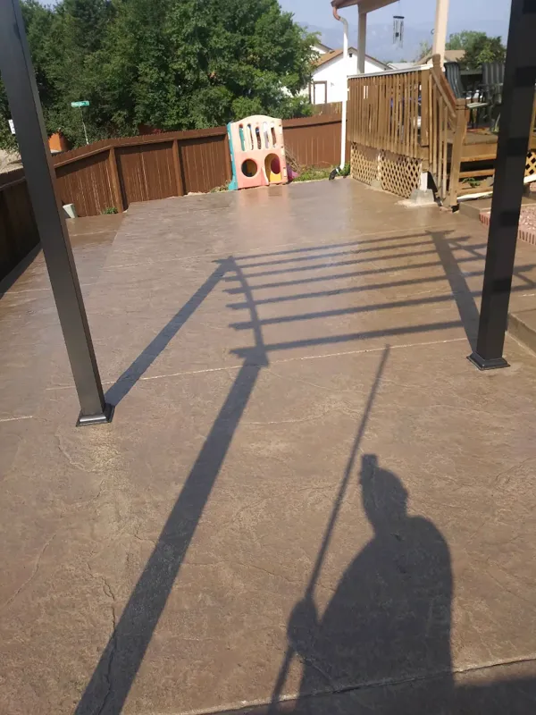 Decorative stamped concrete overlay on a backyard patio in Colorado Springs
